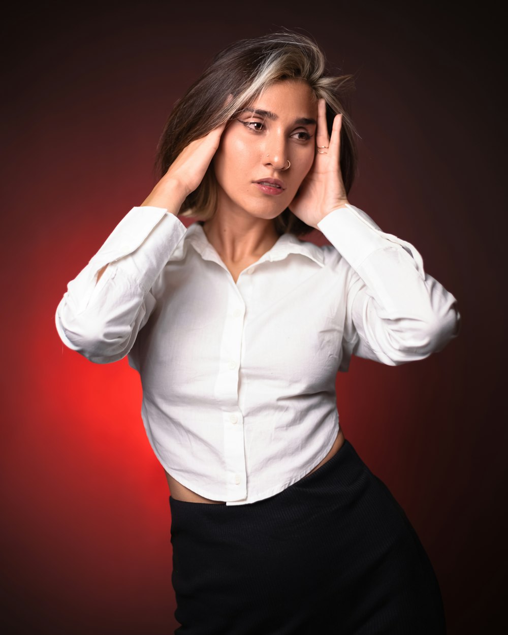 a woman in a white shirt and black skirt