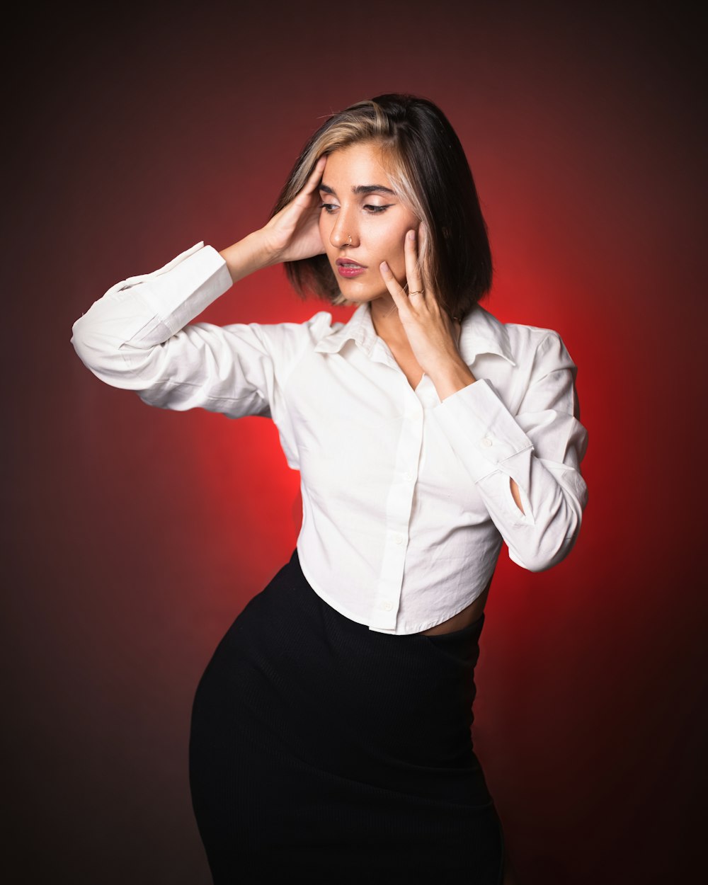 a woman in a white shirt and black skirt