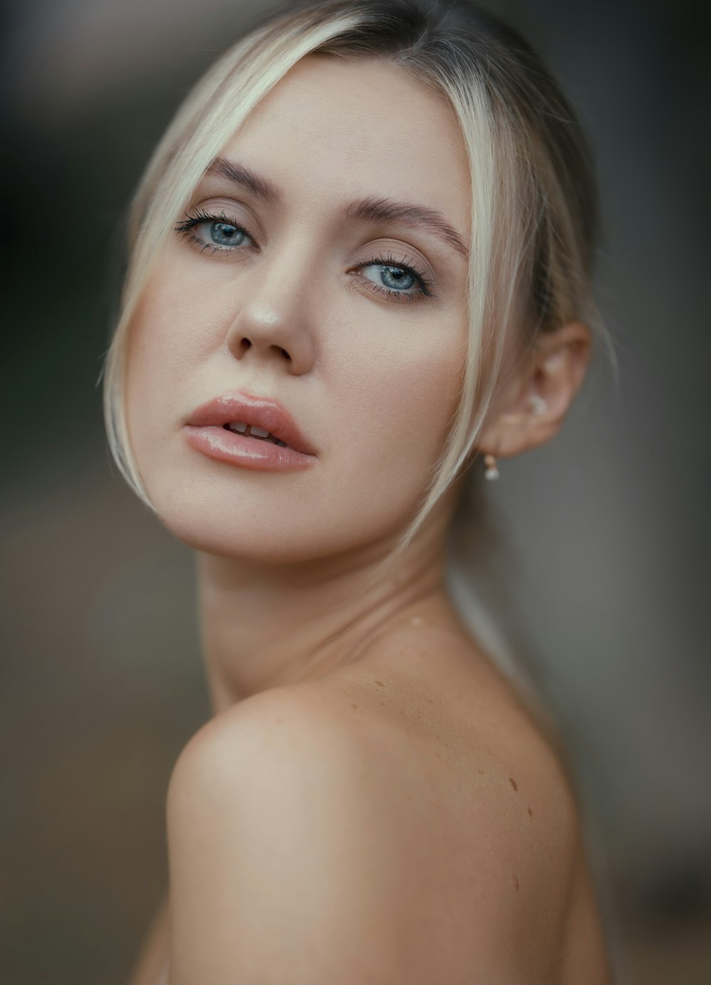 a close up of a woman with blue eyes