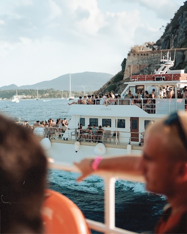 A modern passenger boat cruising on calm waters with passengers enjoying the ride.