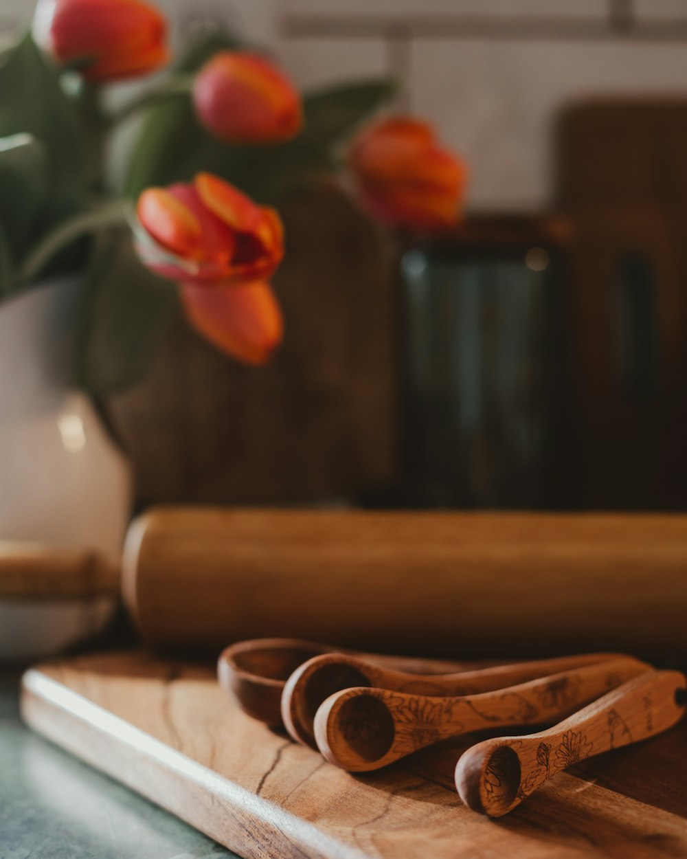 a wooden cutting board with a rolling pin on top of it