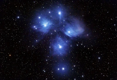 A striking photo of a vibrant star cluster glowing against the dark night sky.