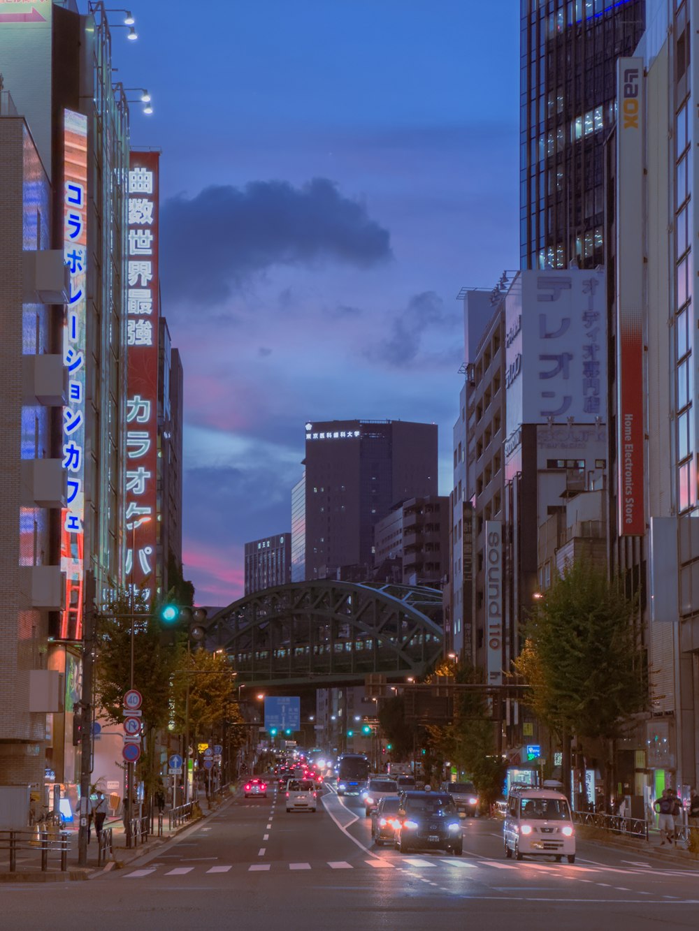 a city street filled with traffic and tall buildings