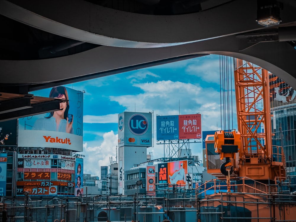 a construction site with billboards and cranes in the background