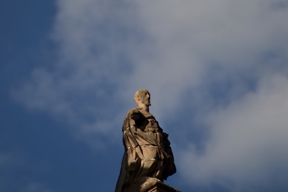 a statue of a man with a bird on his shoulder