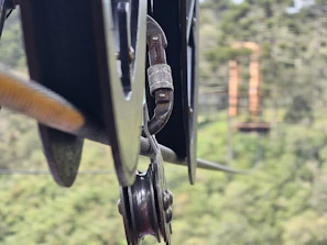 Close-up of the adjustable tree system showing nylon straps and hose clamps securing perches.