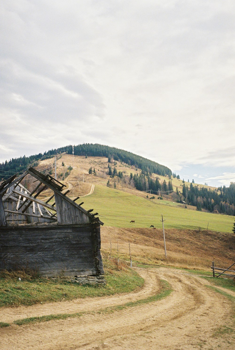 a dirt road in front of a wooden building