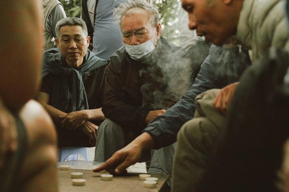 a group of men playing a game of checkers