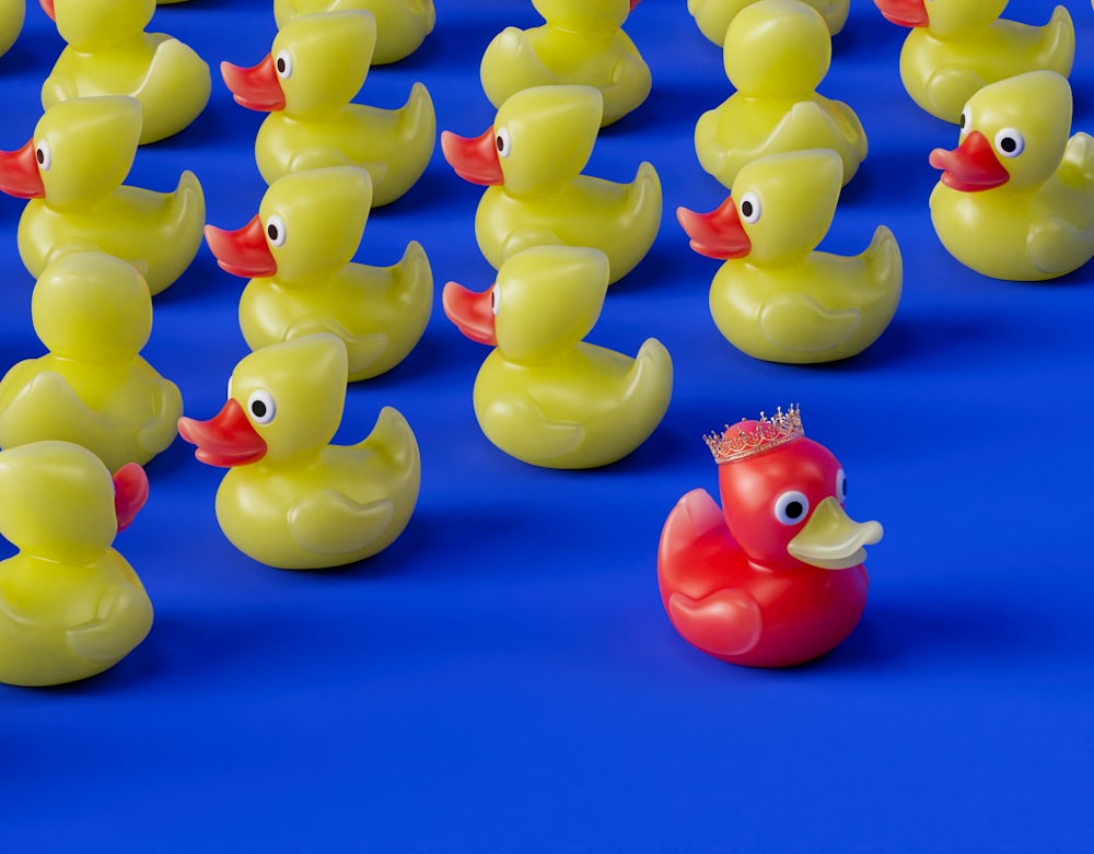 a group of rubber ducks with a crown on their head