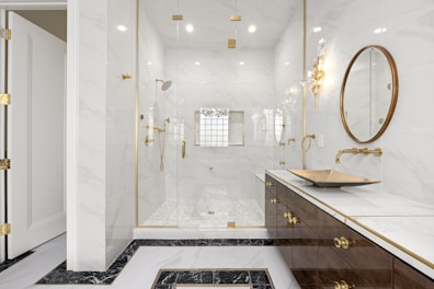A modern bathroom with elegant fixtures and a spacious shower.