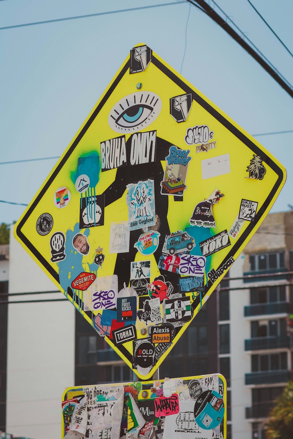a street sign with a lot of stickers on it