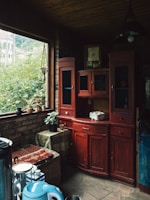 Before and after shots of a restored wooden cabinet in a cozy home setting