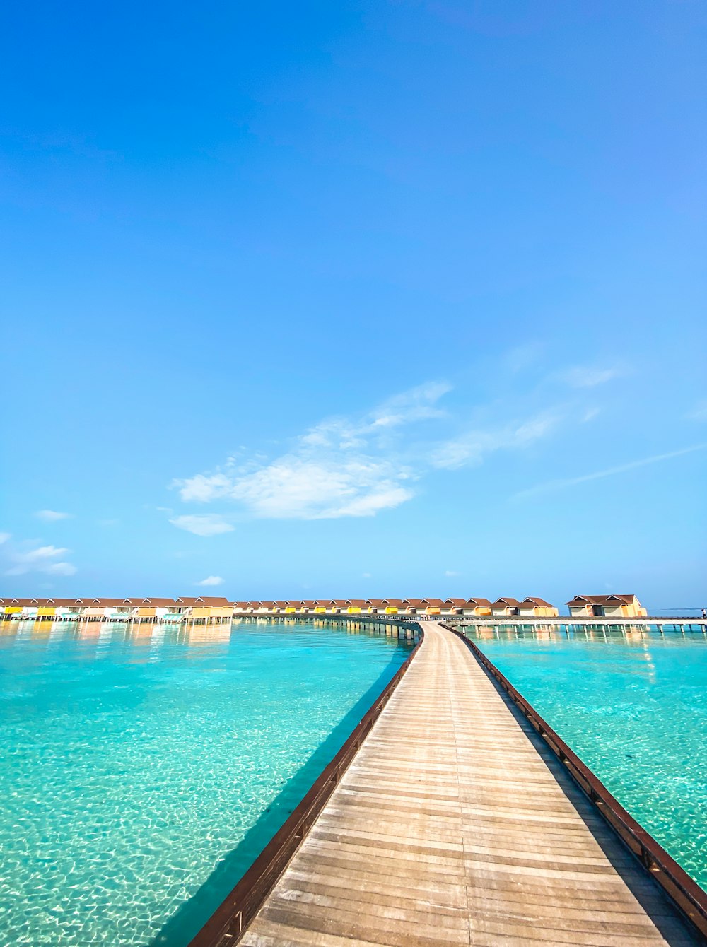 a long wooden pier extending into the ocean