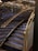 A staircase with luxurious features including glass and gold handrails, complemented by reflective wall panels that create a rich, elegant ambiance.