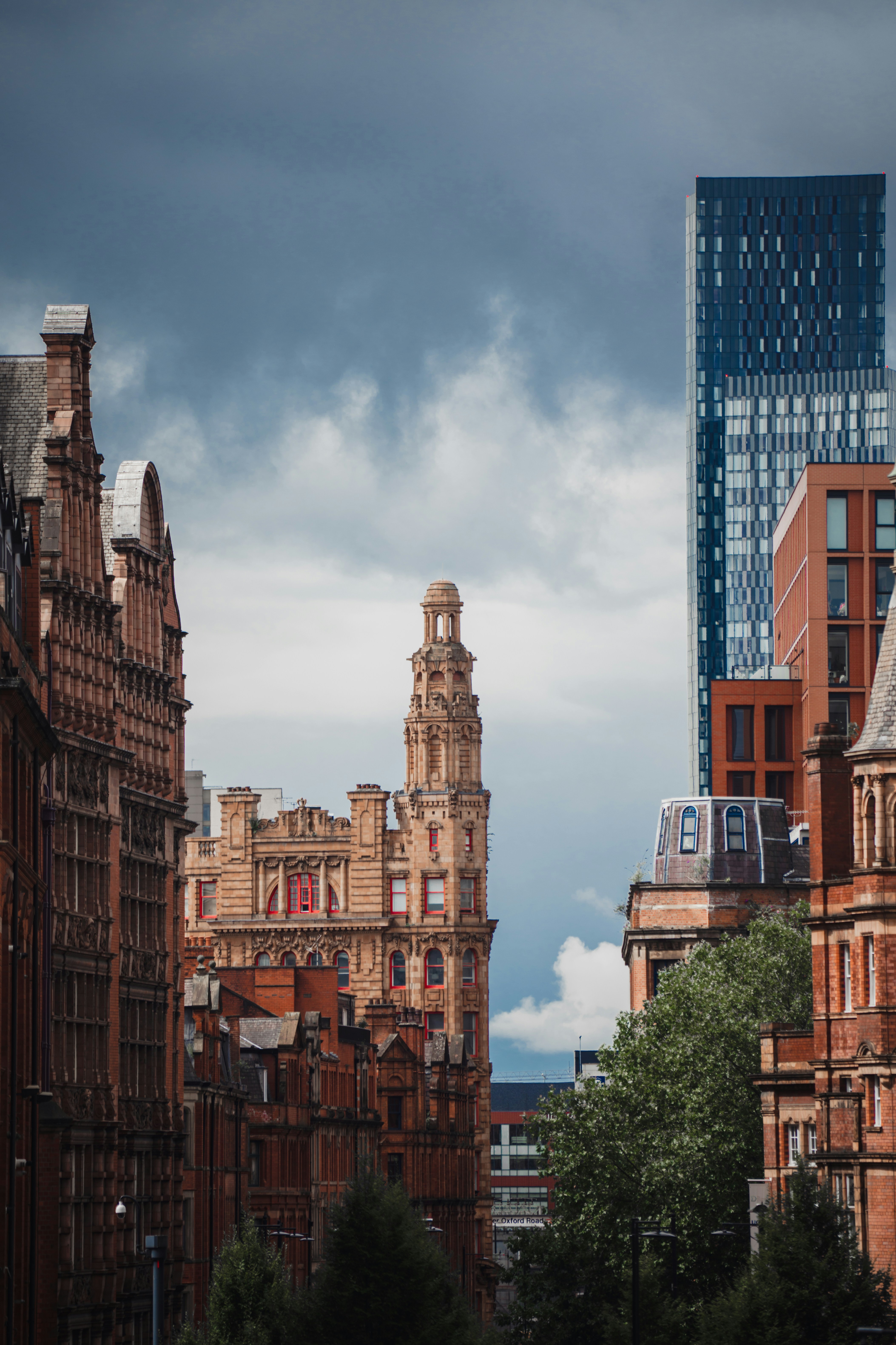 a view of a city with tall buildings and a cloudy sky