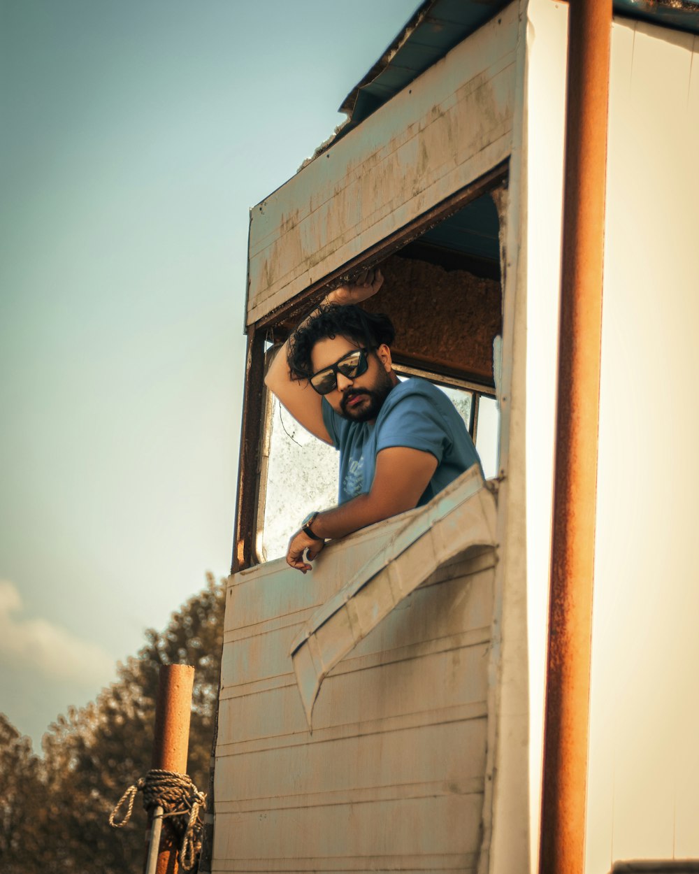 a man looking out of the window of a truck