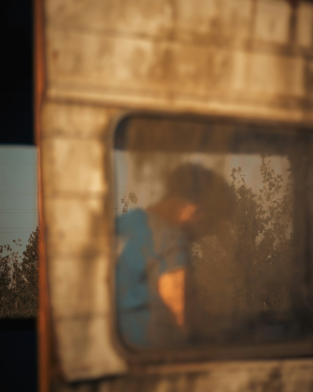 a blurry image of a person looking out of a window