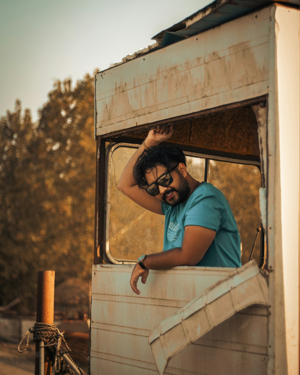 a man leaning out the window of an old truck