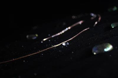 Close-up of a delicate 18k Italian gold chain shimmering under soft light