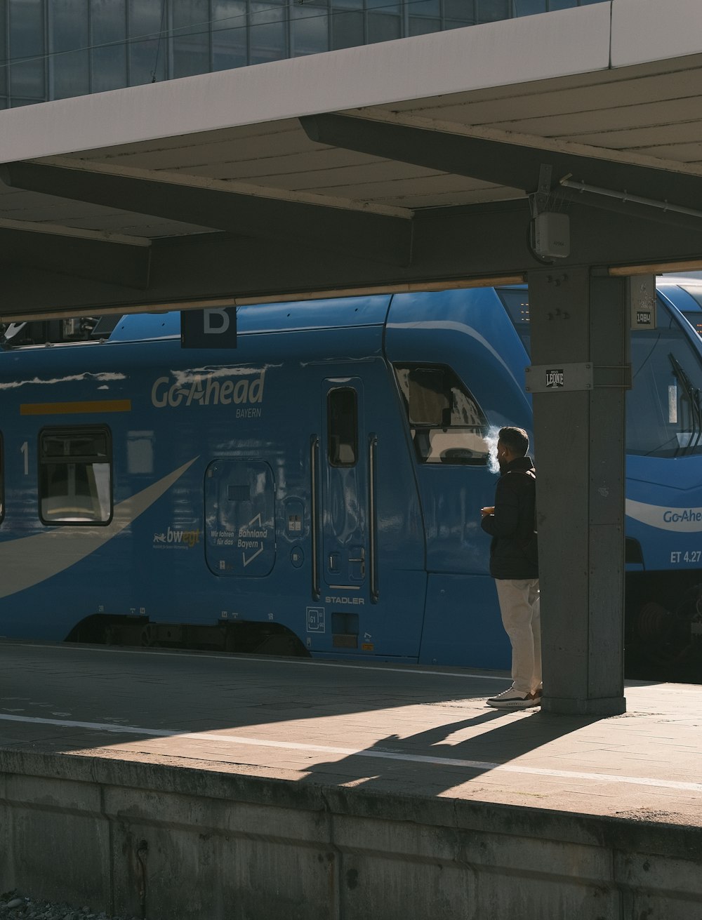 a blue and white train at a train station