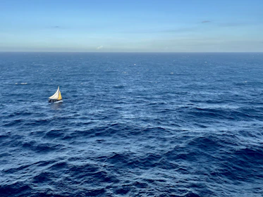 a sailboat in the middle of the ocean