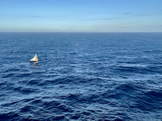 a sailboat in the middle of the ocean