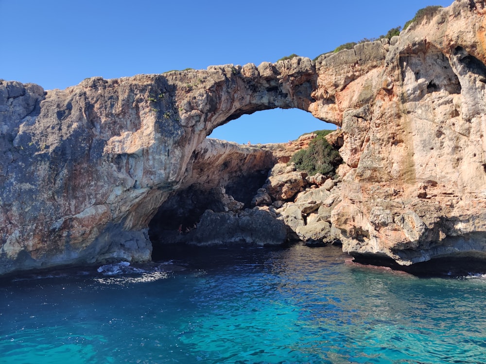a rock arch over a body of water