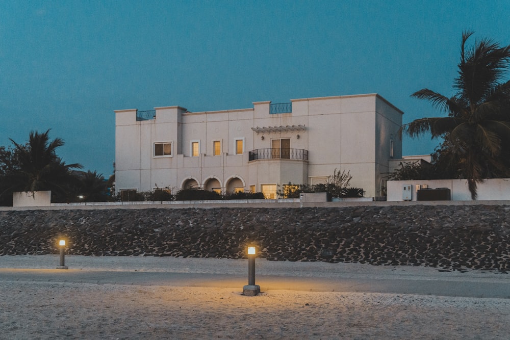 a large white building with two lights in front of it