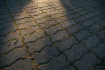 Wide shot of a natural pavement project in progress surrounded by greenery