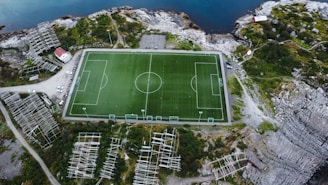 an aerial view of a soccer field in the mountains