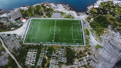 an aerial view of a soccer field in the mountains