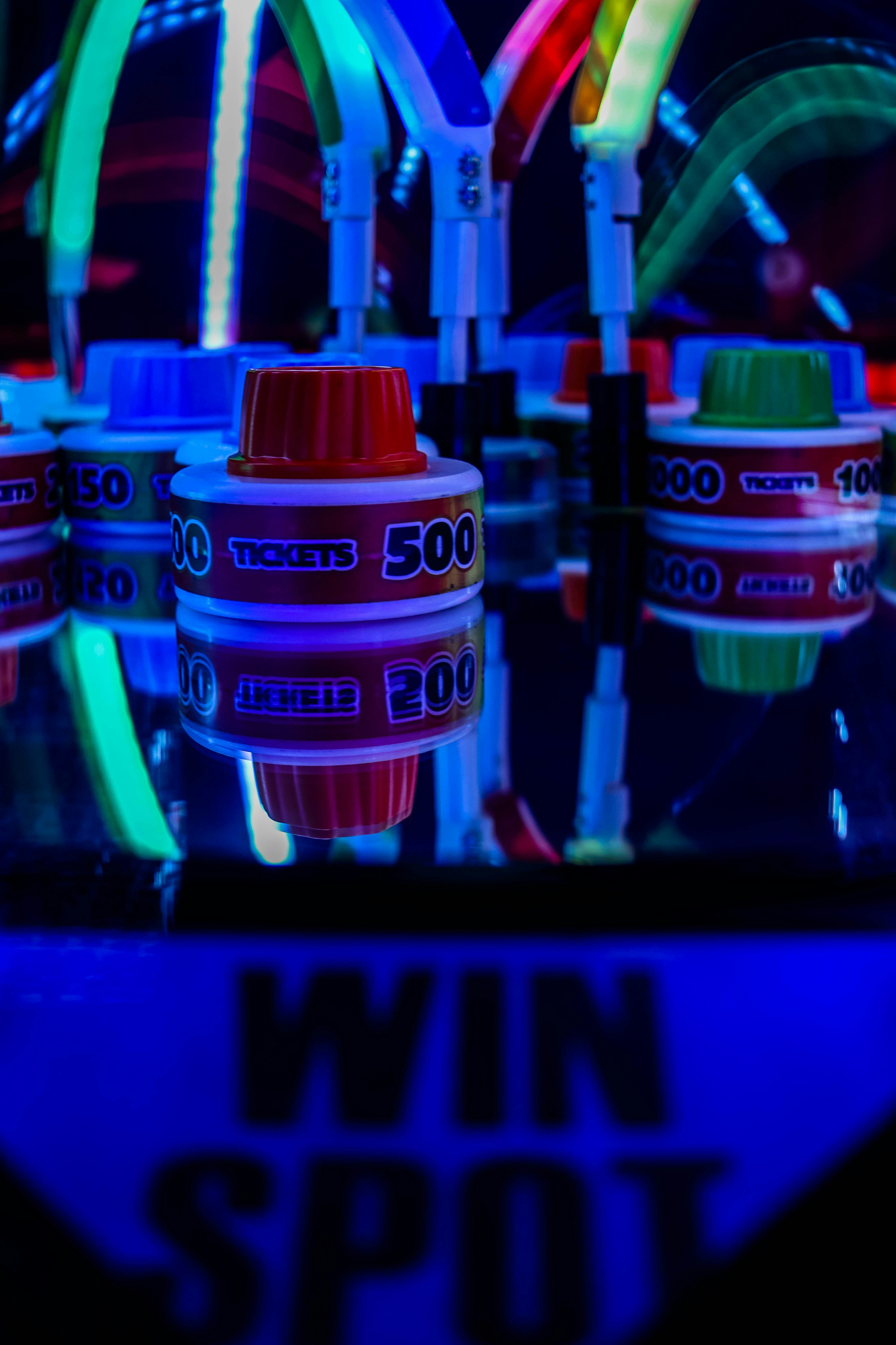 a close up of a neon sign with lights in the background