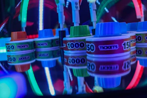 Close-up of glowing neon green cricket coupon cards stacked on a sleek black surface with gold coins scattered around