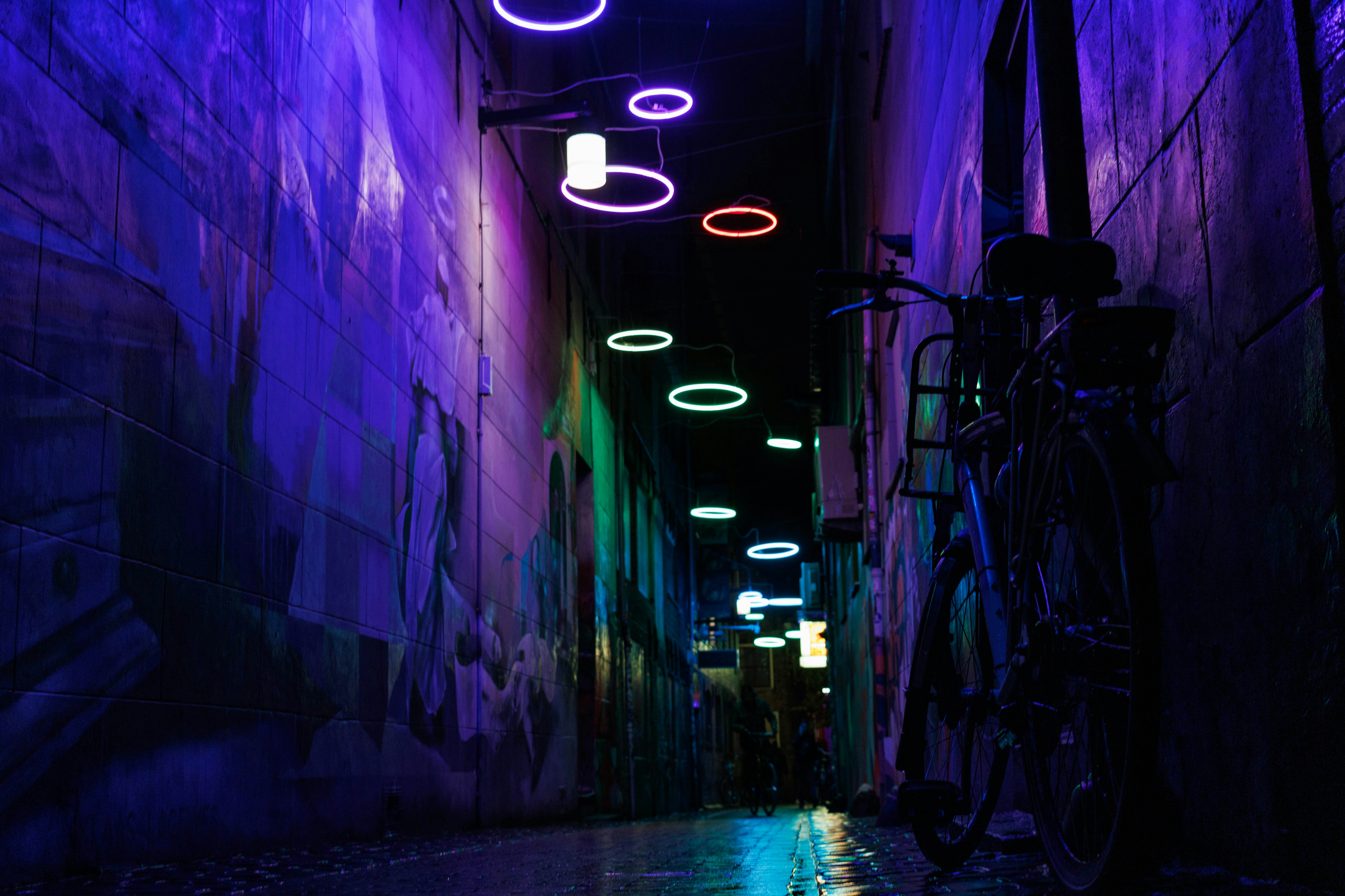 a bike parked on the side of a street next to a wall