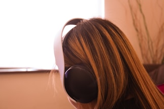 a woman with long hair wearing headphones