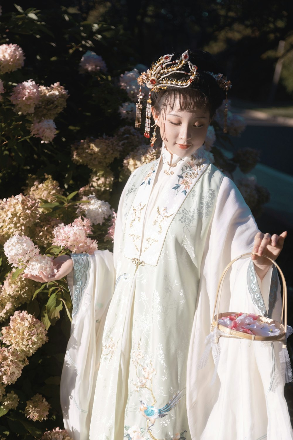 a woman in a white dress holding a basket