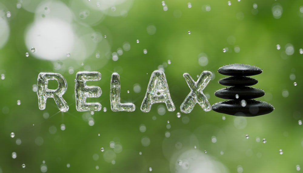 the word relax spelled out of water and rocks