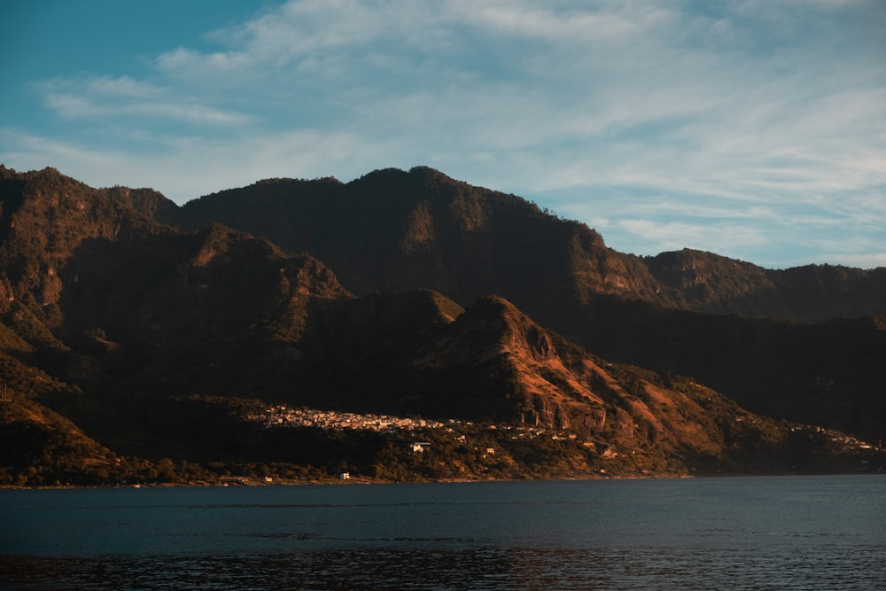 a body of water with mountains in the background