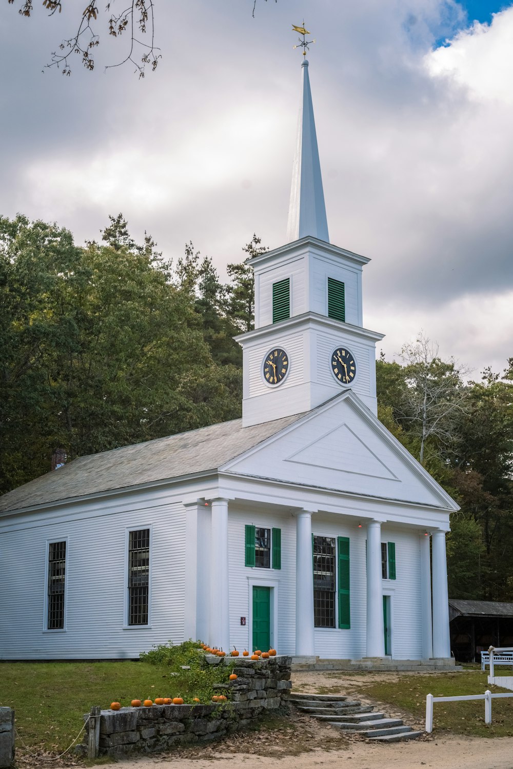 a white church with a steeple and a clock tower