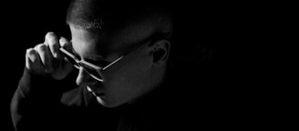 A candid moment of an influencer adjusting his gear, framed by warm gold highlights against a dark background.