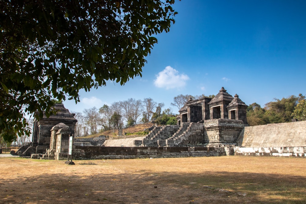 a large stone structure in the middle of a field