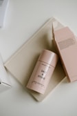 a pink container sitting on top of a table next to a box