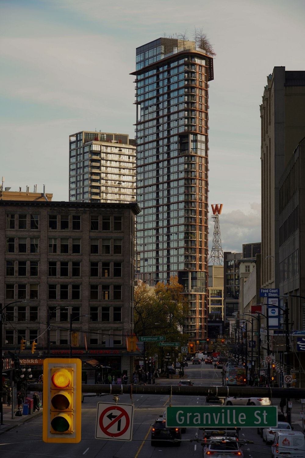 a city street with a traffic light and tall buildings