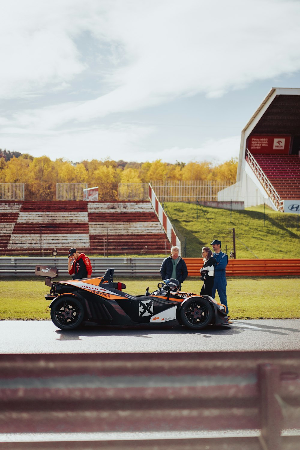 a man standing next to a race car on a track