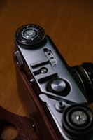 Close-up of a vintage film camera on a tripod, highlighting intricate details.
