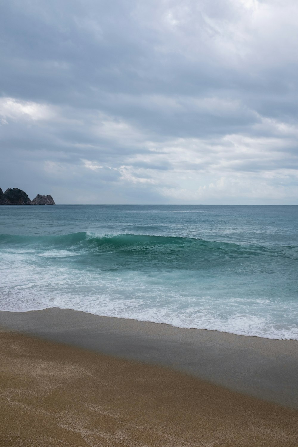 a view of the ocean from a sandy beach