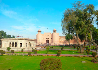 Historic Cellular Jail bathed in soft morning light with visitors walking around.