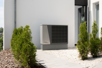 a air conditioner sitting on the side of a building