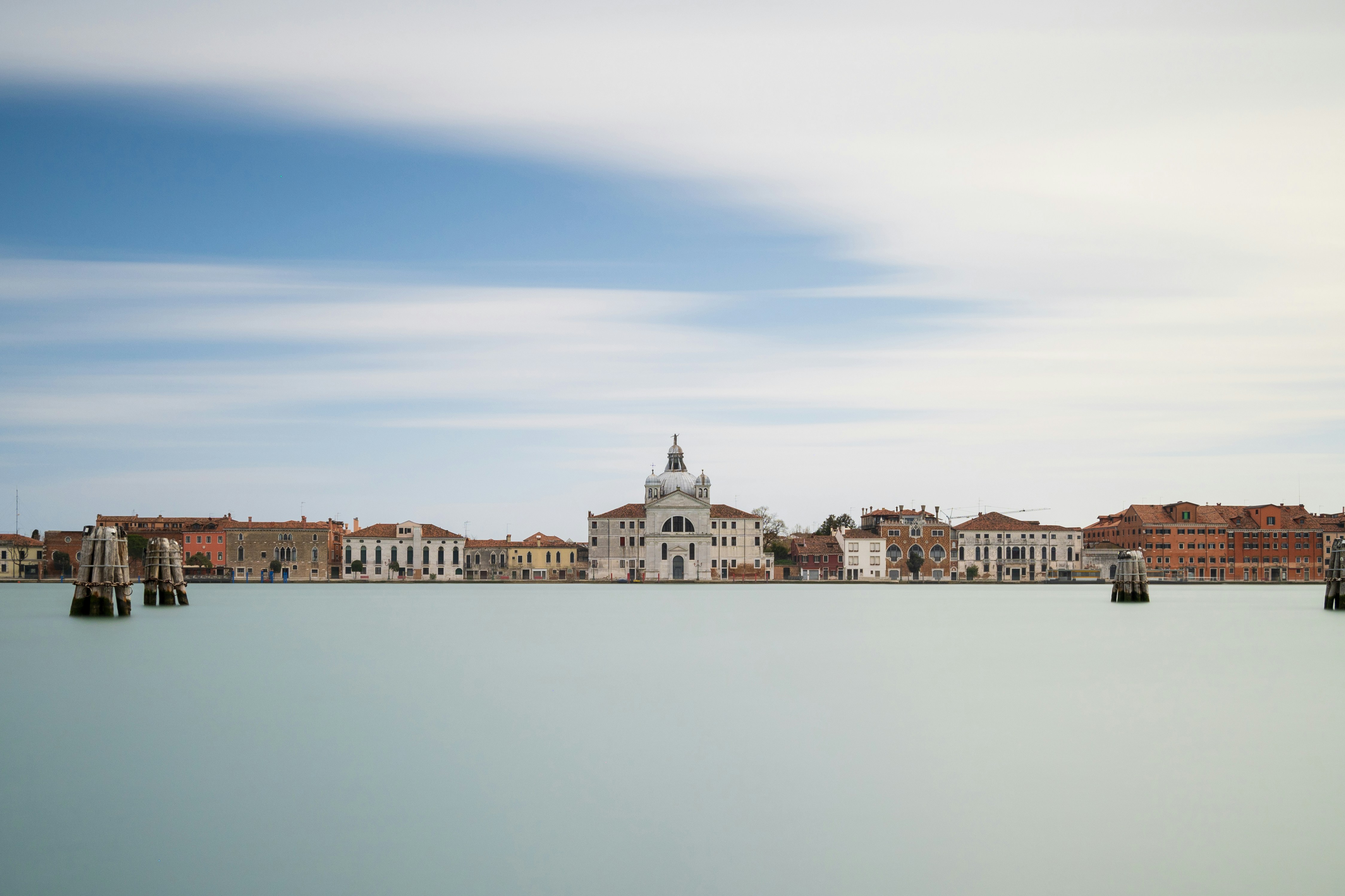 a large body of water with buildings in the background