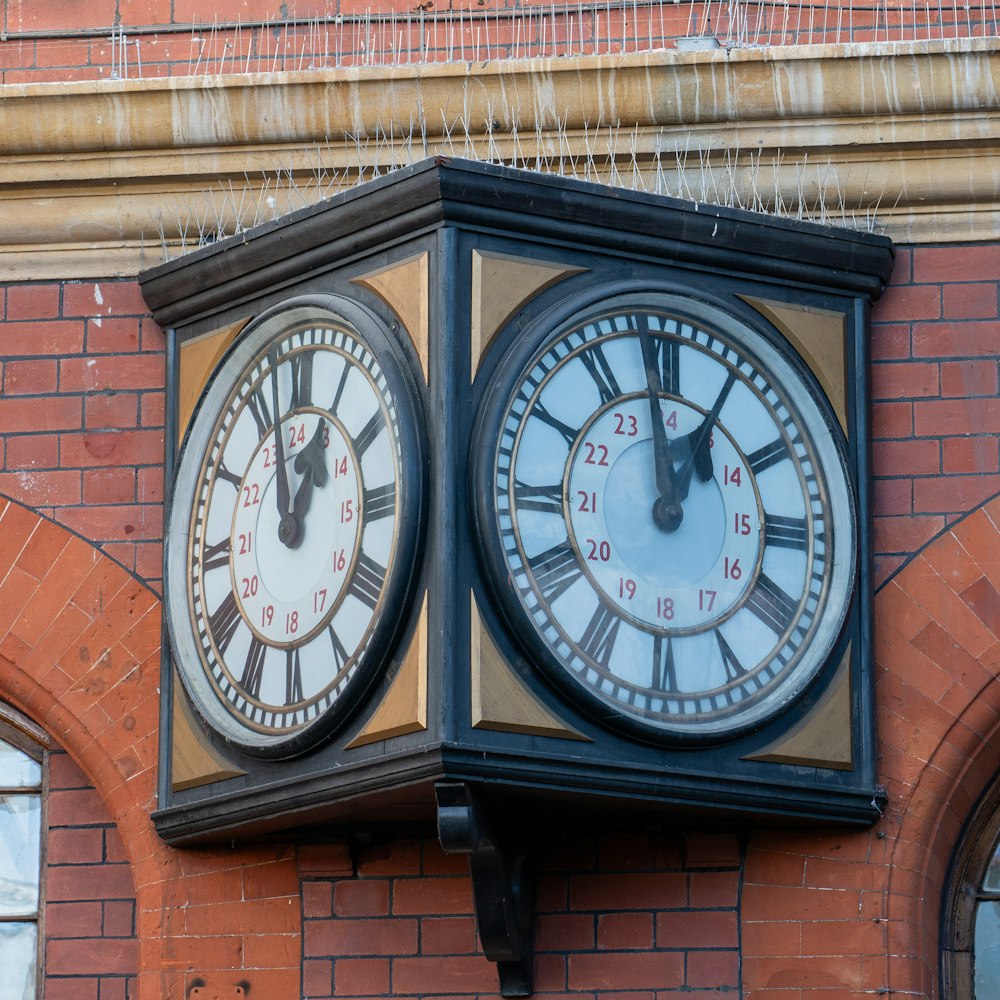 a couple of clocks that are on the side of a building